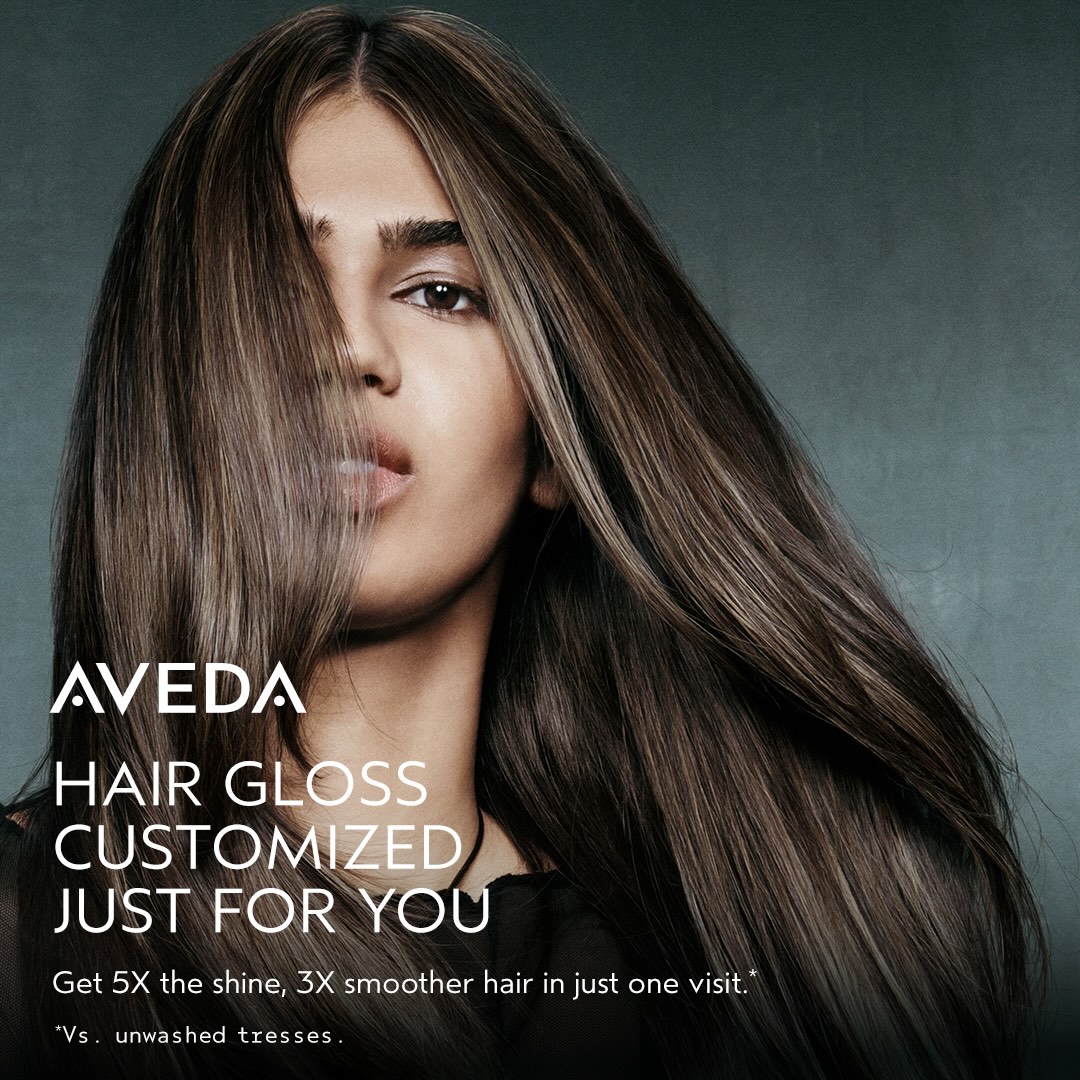 A person with long, shiny, straight brown hair is shown. Text reads "AVEDA Hair Gloss Customized Just For You. Get 5X the shine, 3X smoother hair in just one visit. - True Blue Salon | Nashville, TN